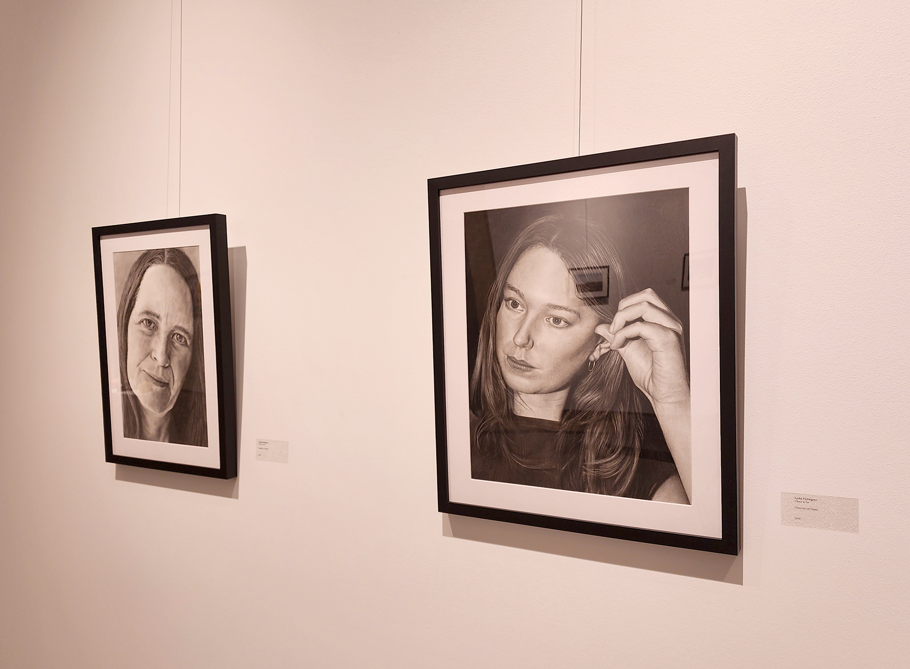 Lydia Holmgren's charcoal self-portrait "Choose to See," right, received a Best in Show Award, and was displayed alongside another Holmgren portrait.